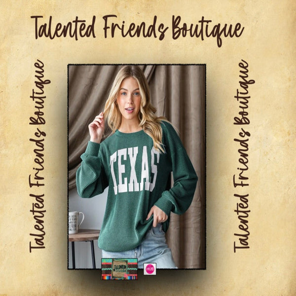 Woman wearing a green ribbed knit top with 'TEXAS' printed in white 